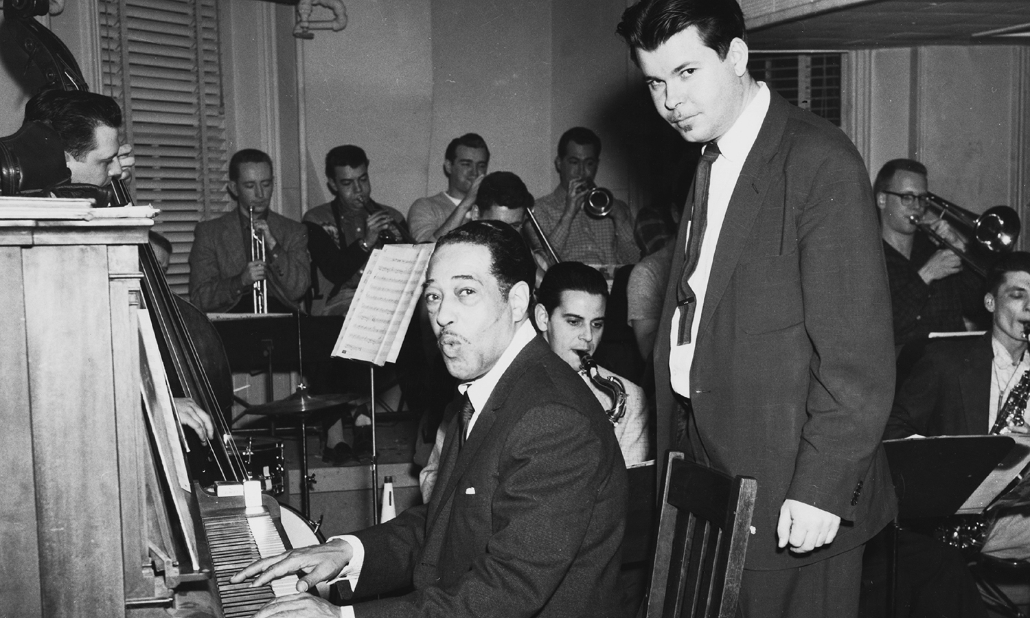 Black and white photograph of Duke Ellington at the piano.