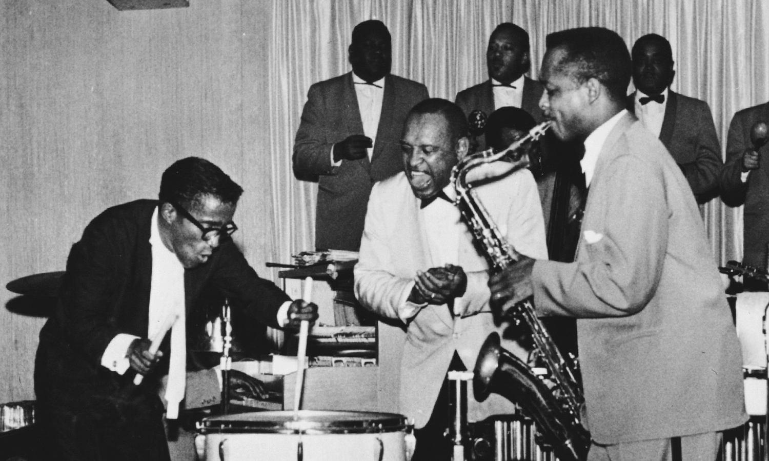 Andy McGhee solos with the Lionel Hampton band. Sammy Davis Jr. plays the drums.