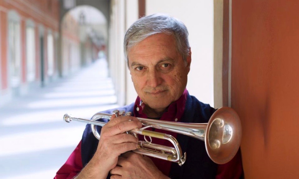 Dusko Goykovich holding a trumpet.