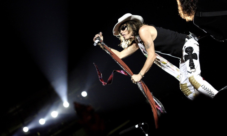 Steven Tyler on stage with a microphone.