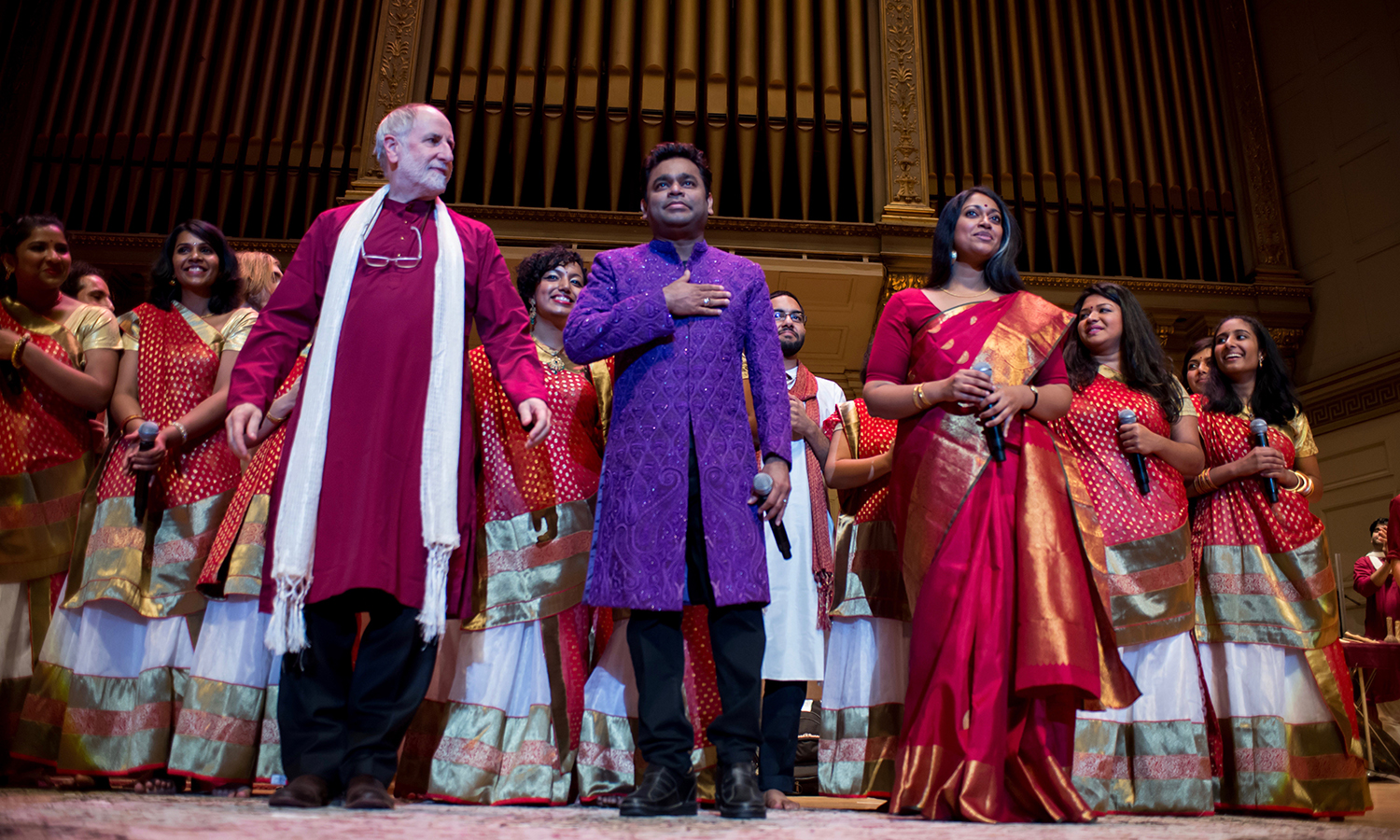 Faculty members Eugene Friesen and Annette Philip flank A. R. Rahman