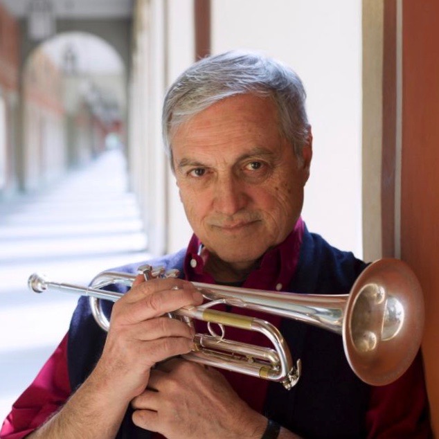 Dusko Goykovich holding a trumpet.