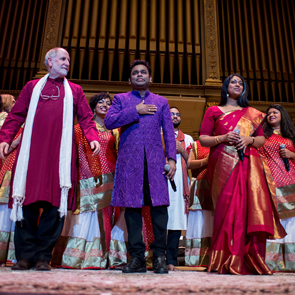 Faculty members Eugene Friesen and Annette Philip flank A. R. Rahman